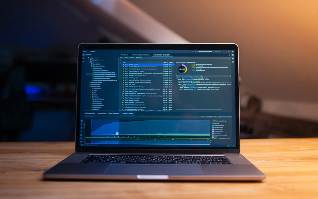 A laptop showing code and build output.